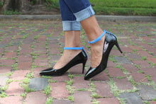 Shoes modeled standing on an original brick street, Houston, TX.